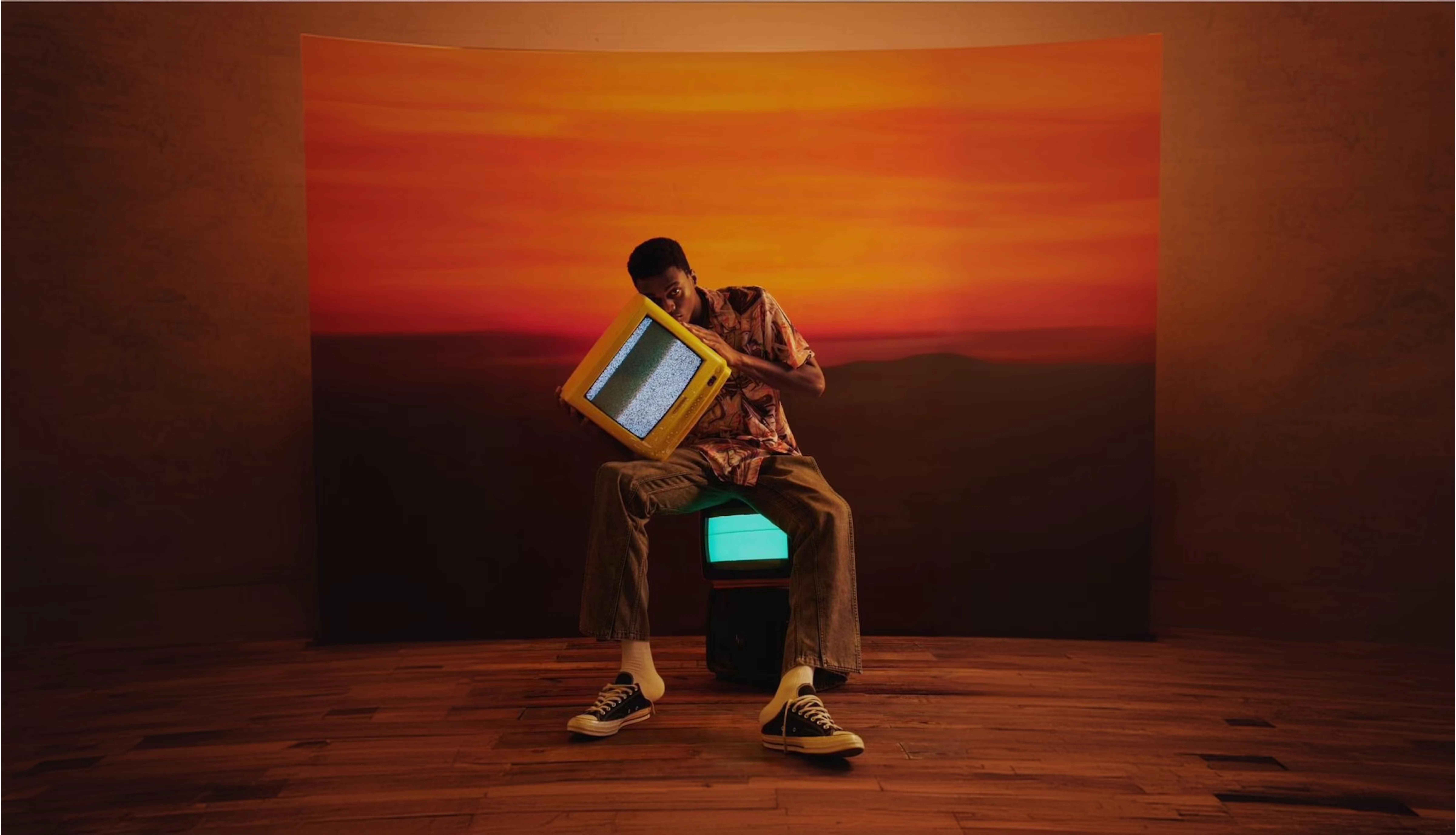 Man holding a yellow TV with static